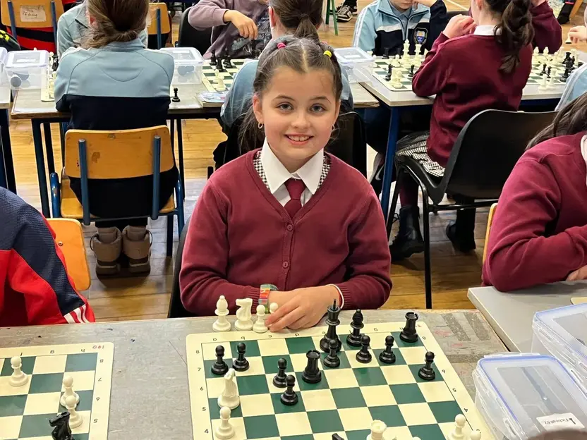 A pupil at a chess board during a schools tournament