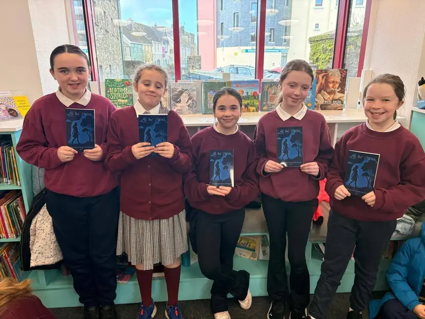Creative Writing Club members holding their published book in Clonakilty library