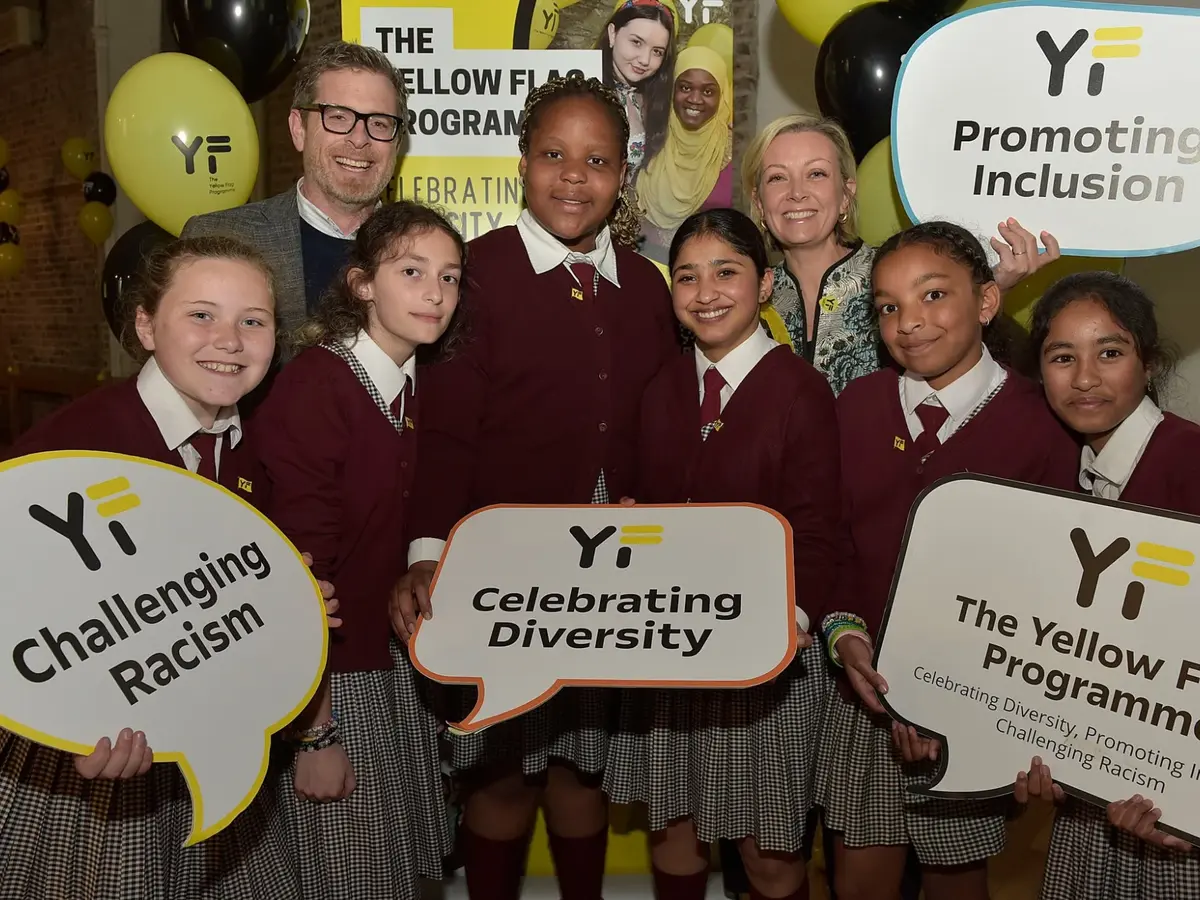 Pupils holding Yellow Flag signs: Challenging Racism, Celebrating Diversity, Promoting Inclusion