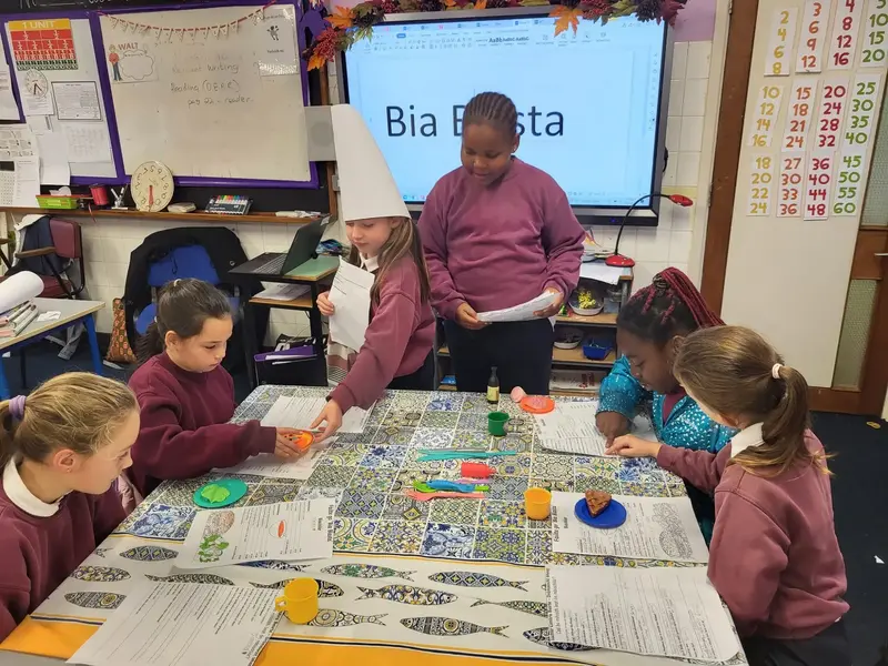 Pupils ordering food as Gaeilge in a pretend restaurant called Bia Blasta