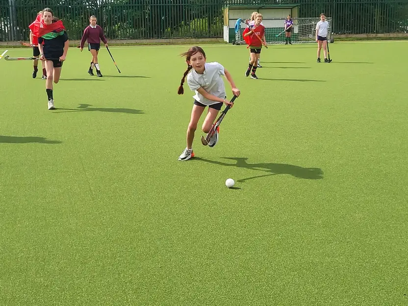 A pupil dribbling a hockey ball during a blitz