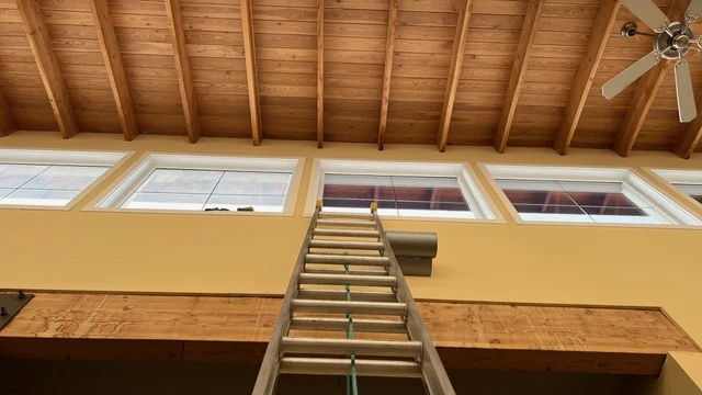 A ladder positioned below high windows at a Falconhurst window-cleaning project
