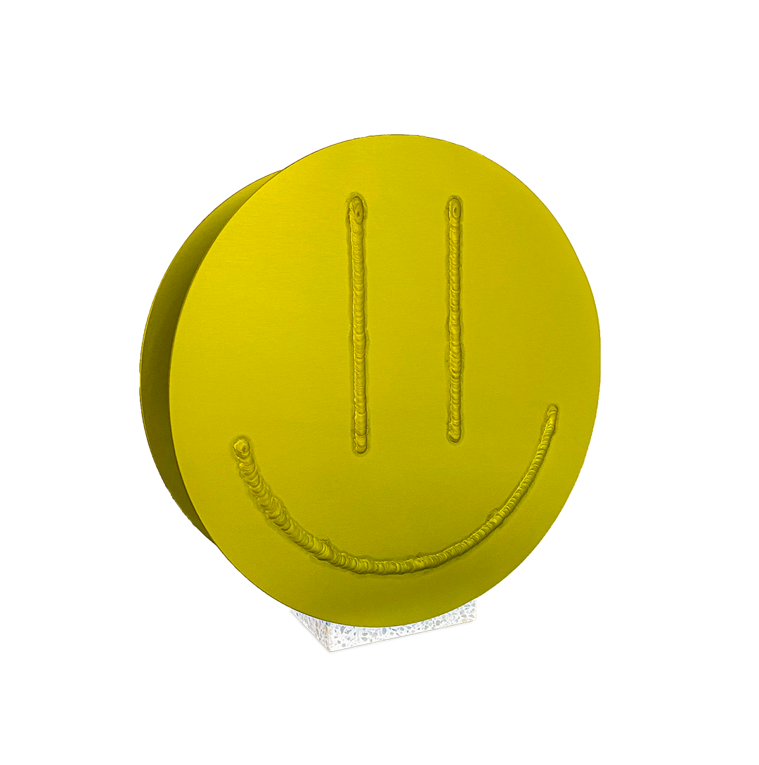 Acid Vase, a round yellow aluminium vase with a welded smiley face