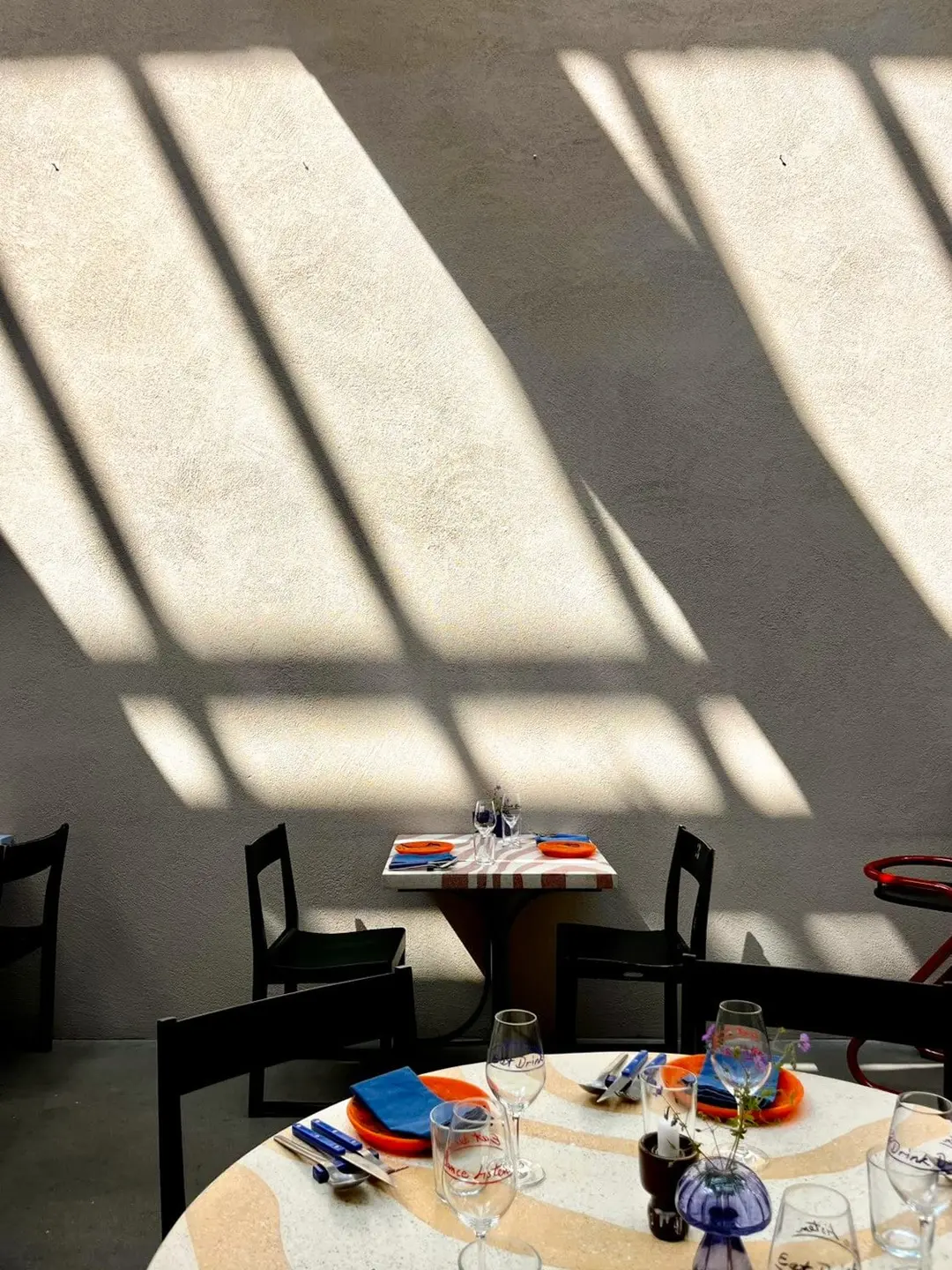 Sunlit dining room at Hosoi with a set round table