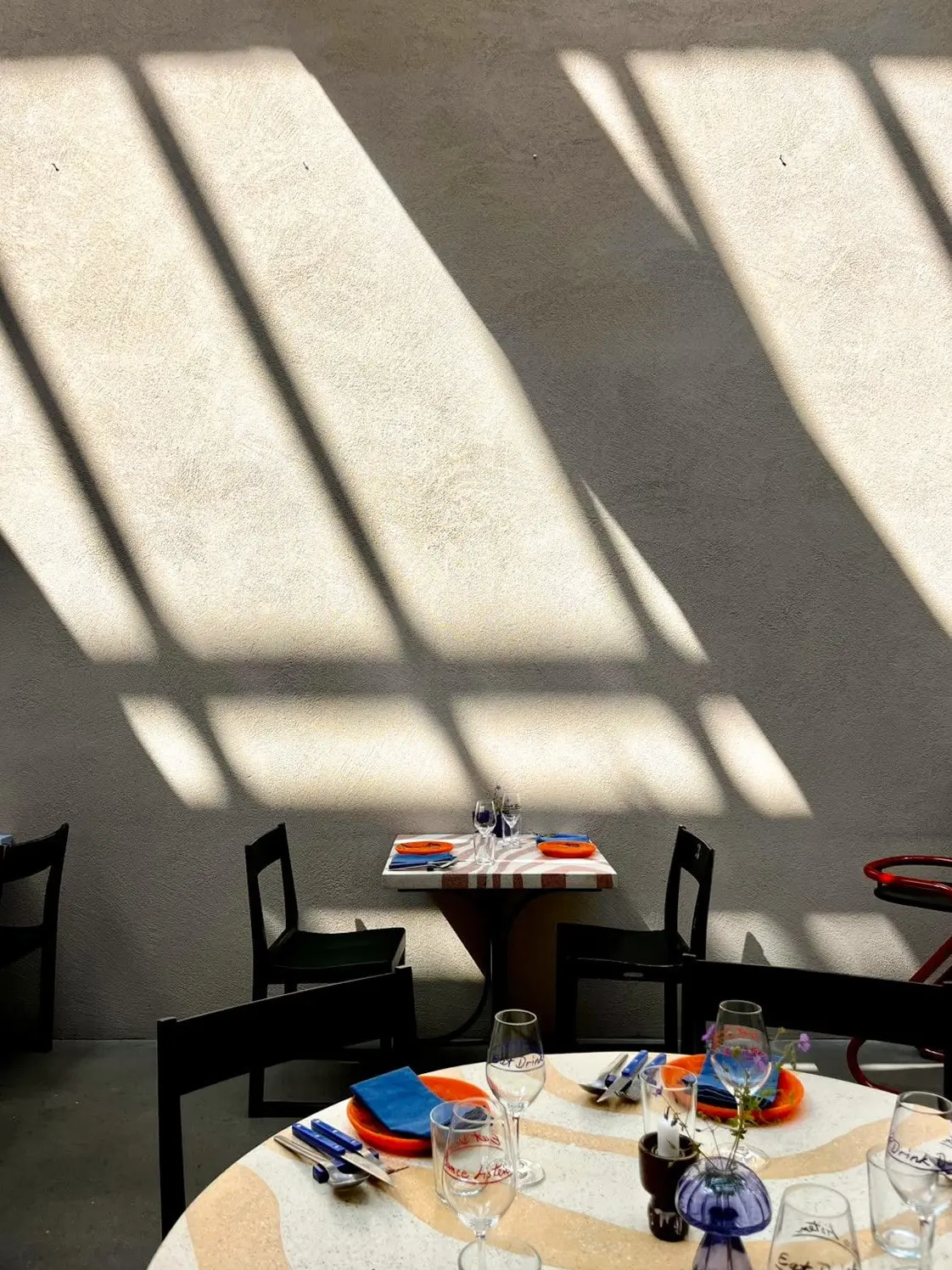 Sunlit dining room at Hosoi with a set round table