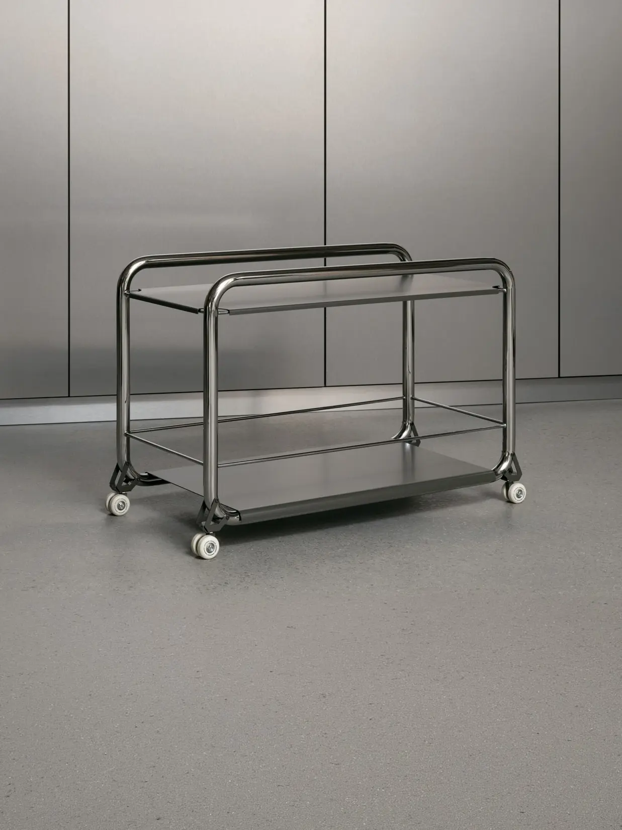 Tension trolley in chrome and stainless steel against a metal wall