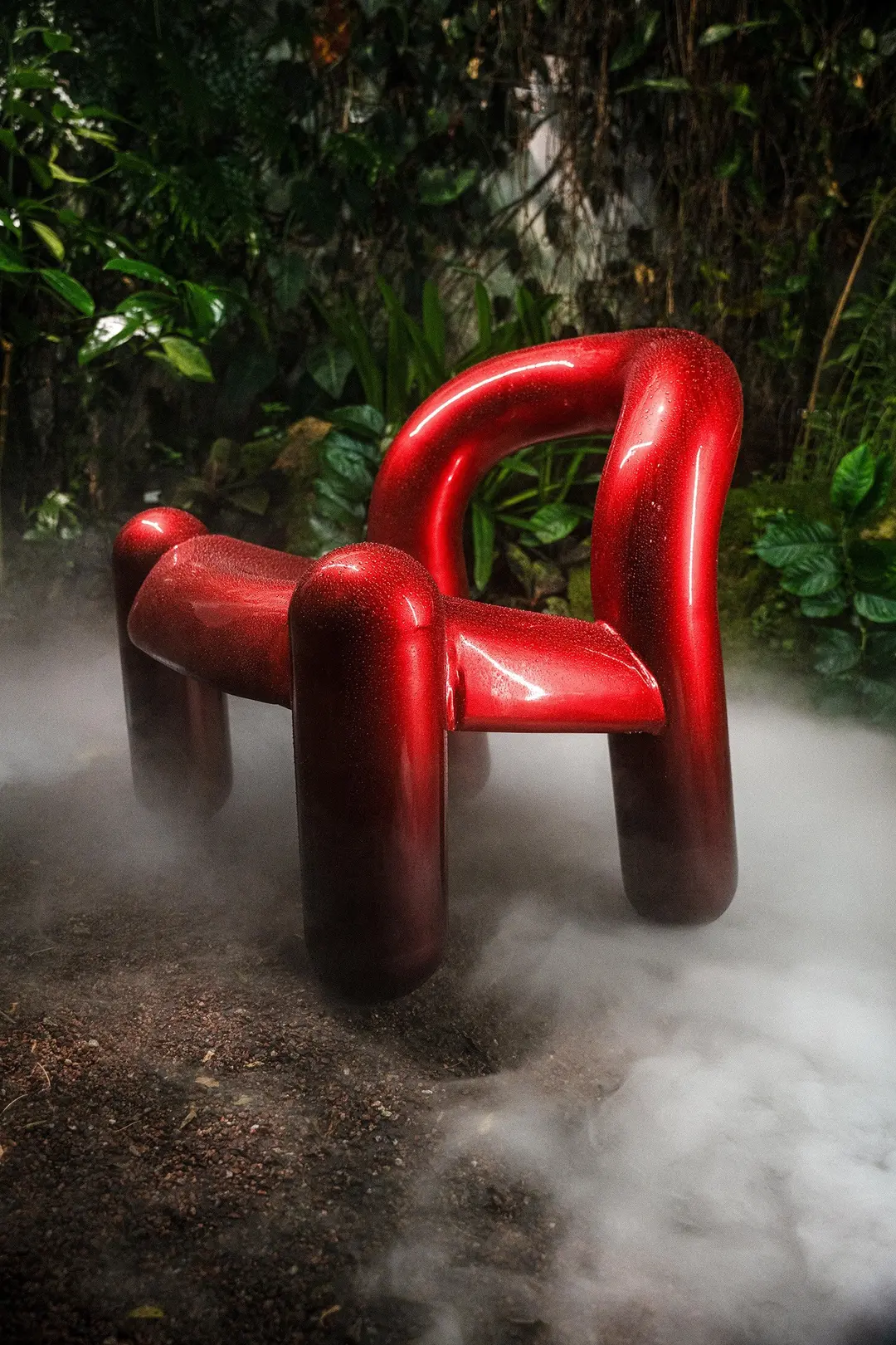 Red Reality armchair in a jungle setting with mist