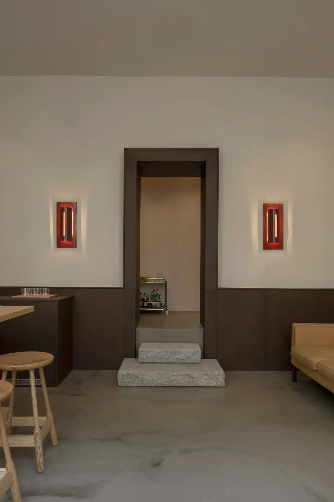 BOBO showroom: a doorway between two red ceramic wall lamps