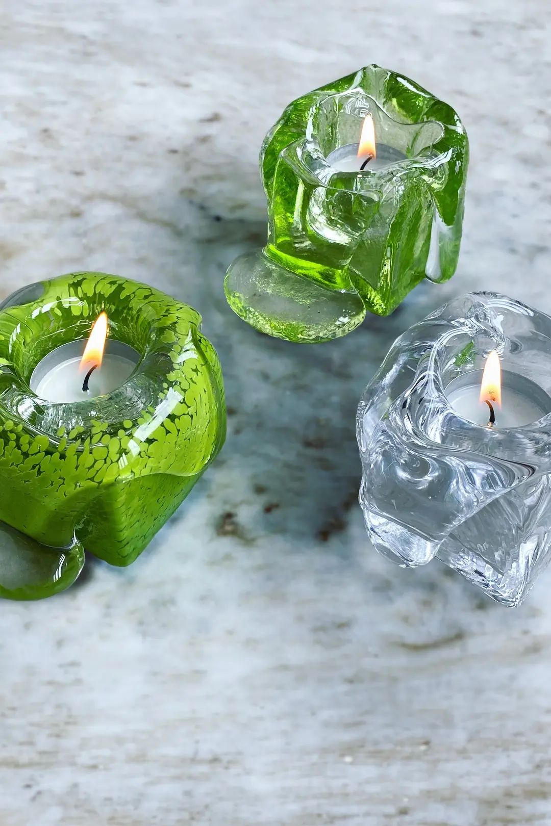 Green and clear Syrup candleholders with lit tealights