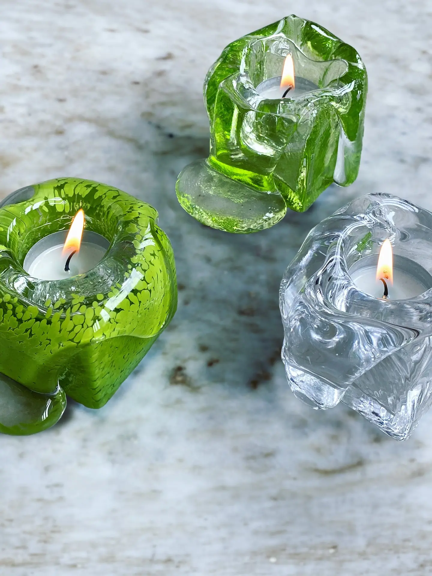 Green and clear Syrup candleholders with lit tealights