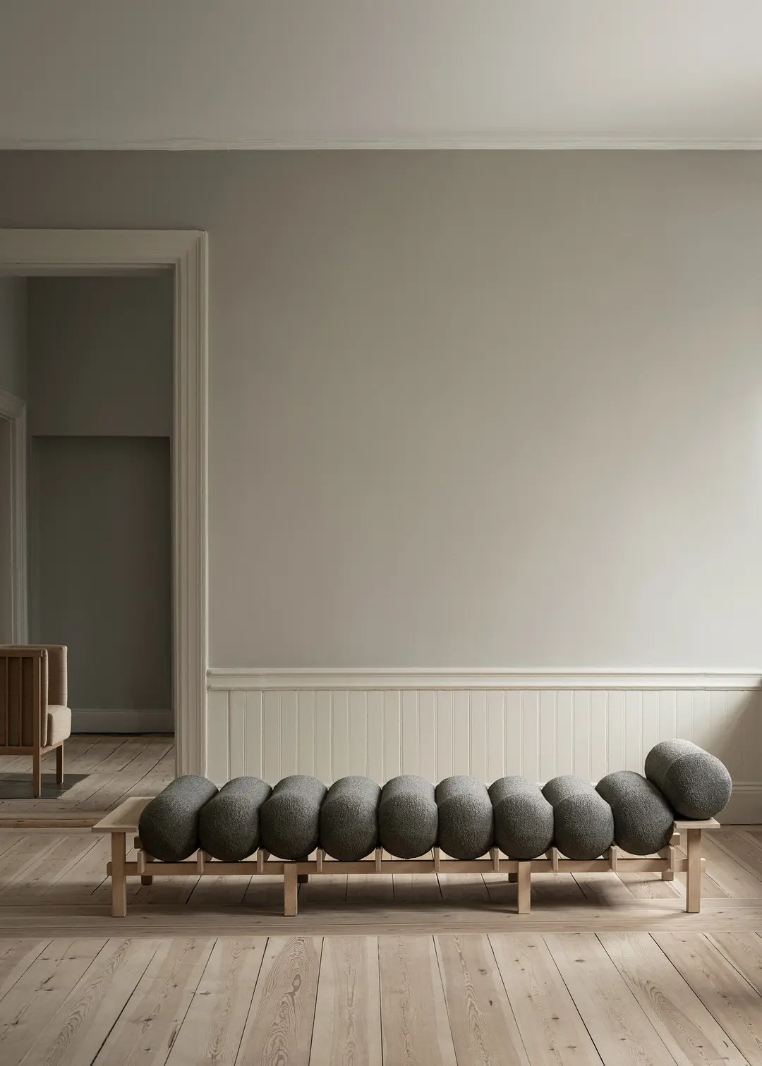 Dag daybed with grey cushions in a bright room with wooden floorboards