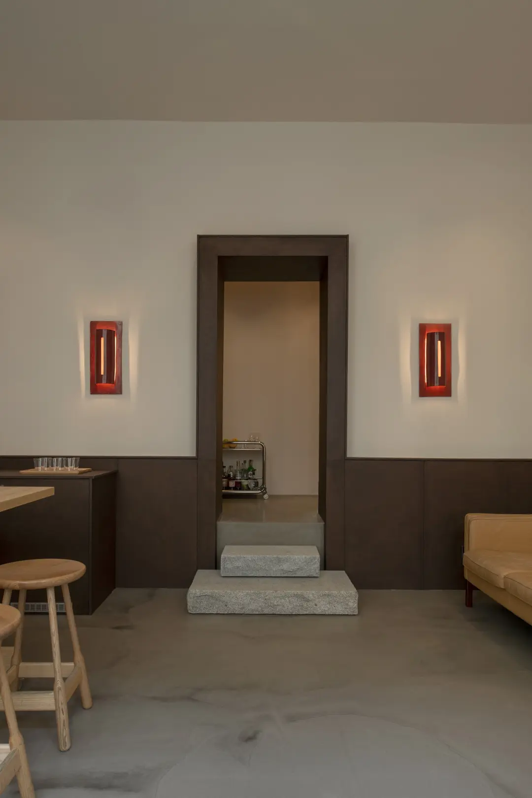 Doorway between two red ceramic wall lamps