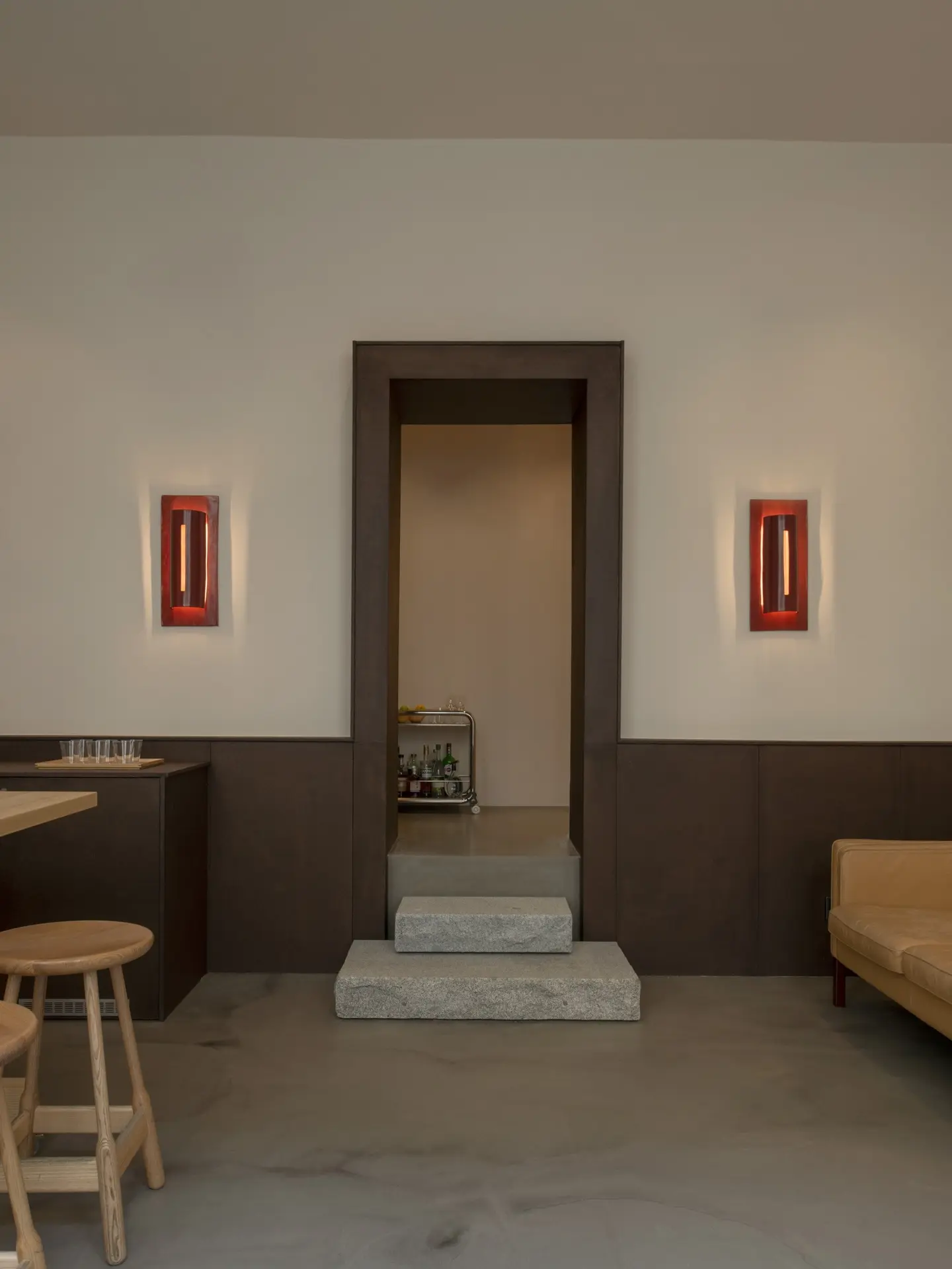 Doorway between two red ceramic wall lamps