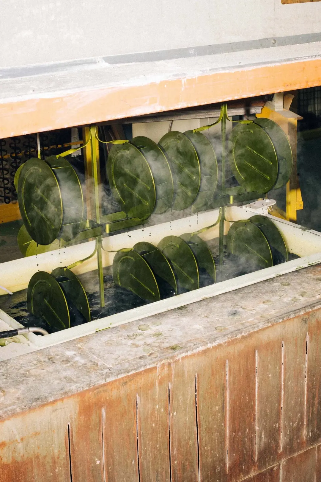 Rows of vases in a steaming anodising tank
