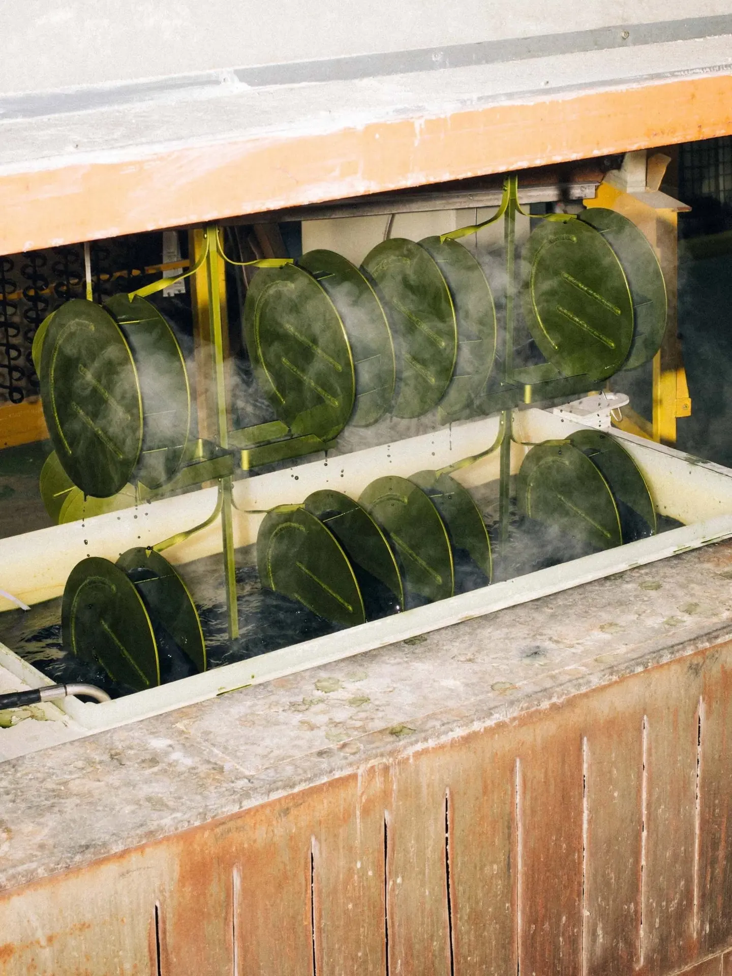 Rows of vases in a steaming anodising tank