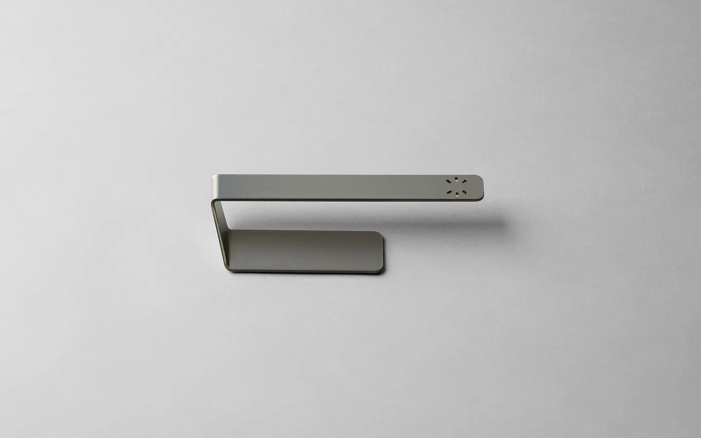 Steel dishcloth hanger on a white surface