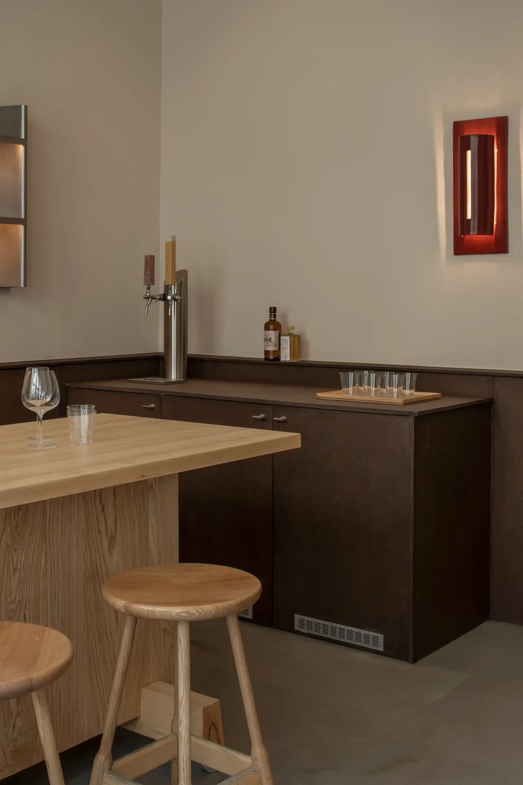 Bar counter with a beer tap and a red wall lamp