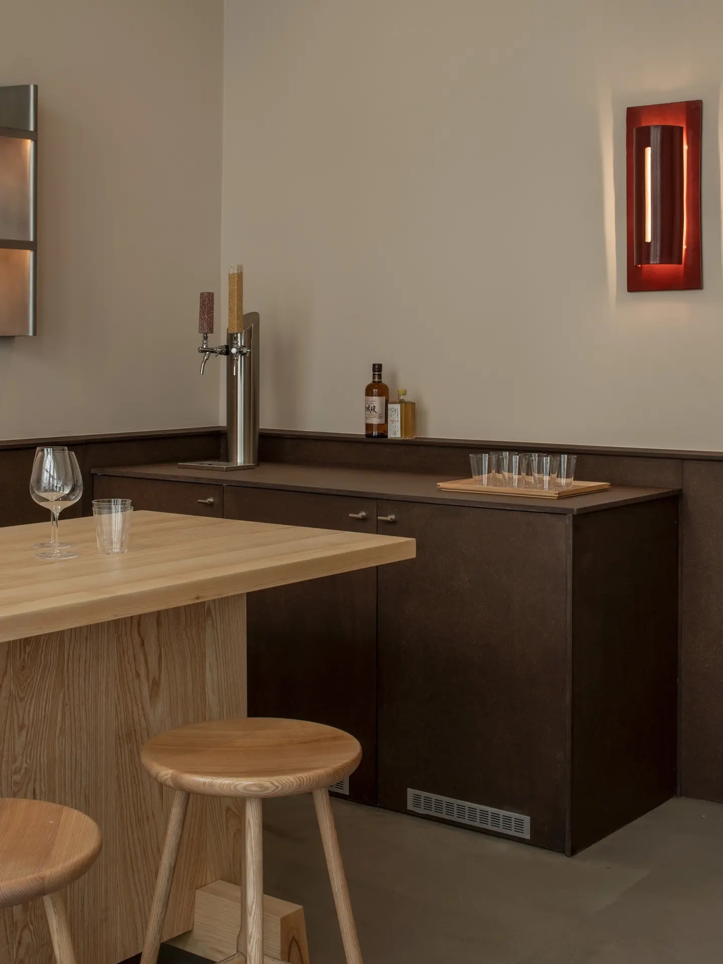 Bar counter with a beer tap and a red wall lamp
