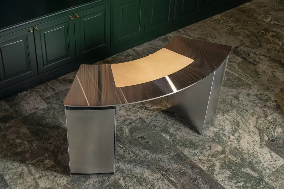 CD desk in front of green panelled cabinets