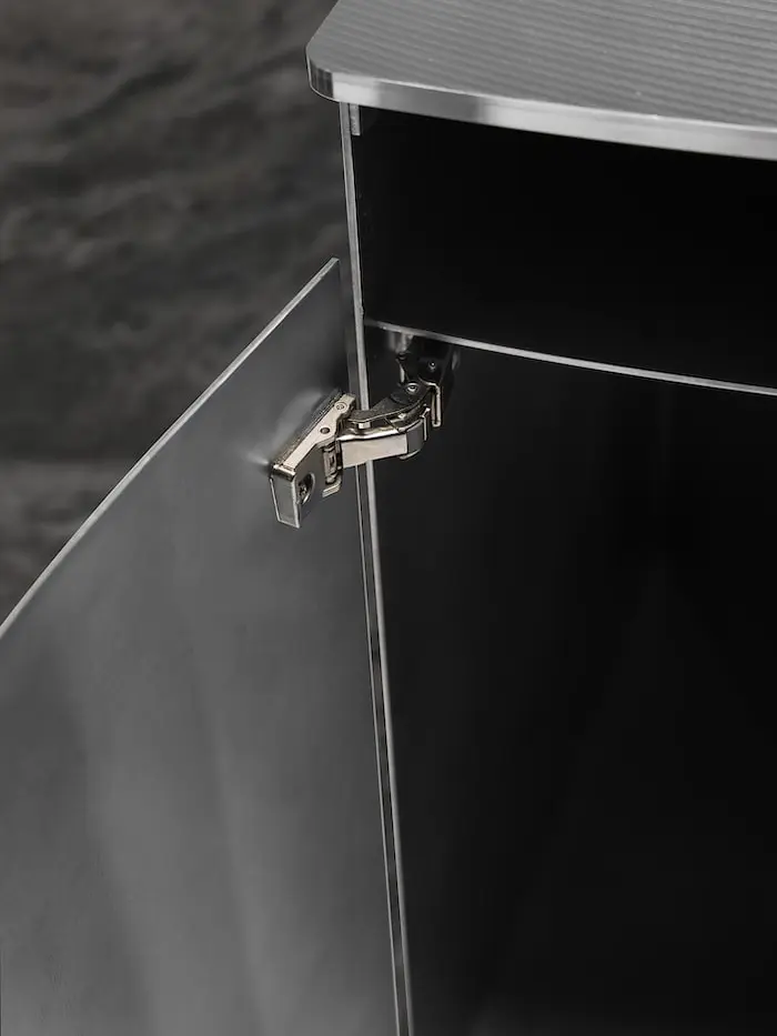 Open aluminium cabinet leg of the desk with its hinge