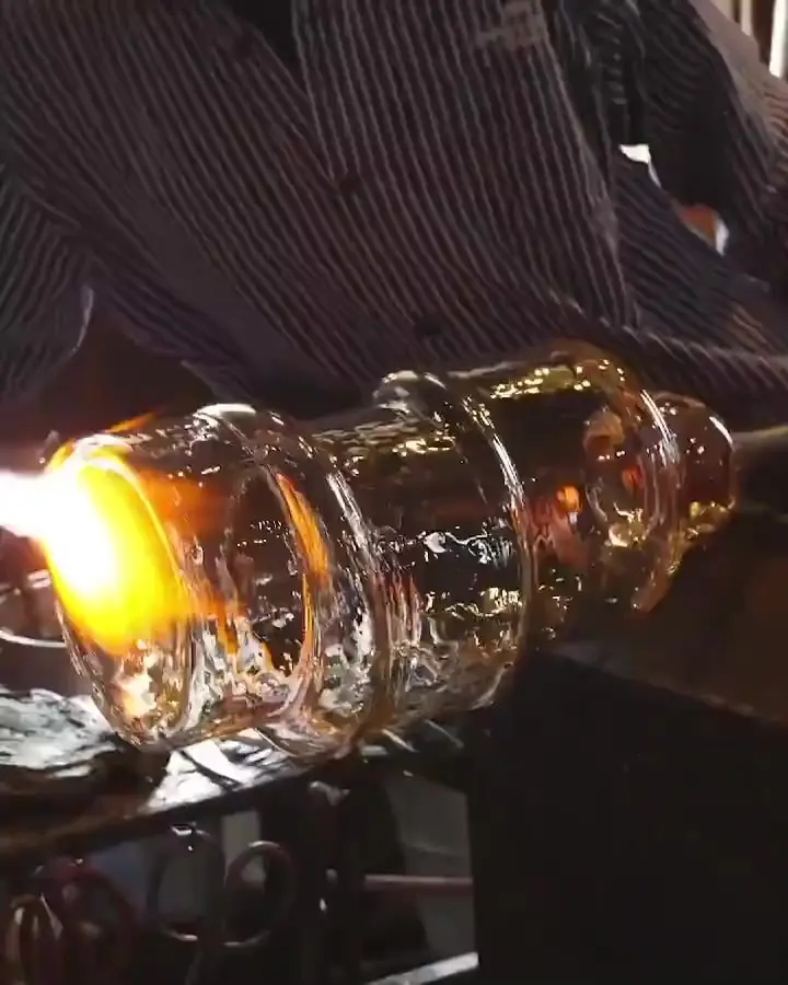 Video: glowing glass being blown into the metal mould