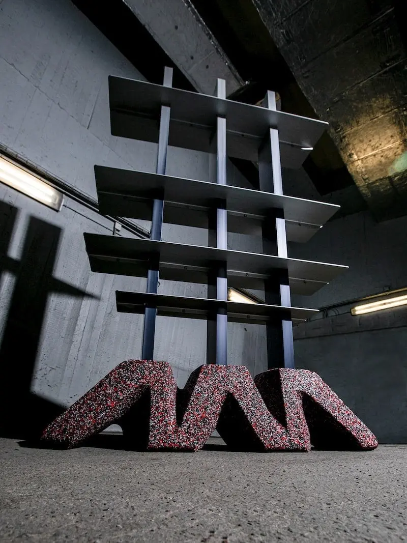 DIO shelf with a speckled base in a dark concrete space