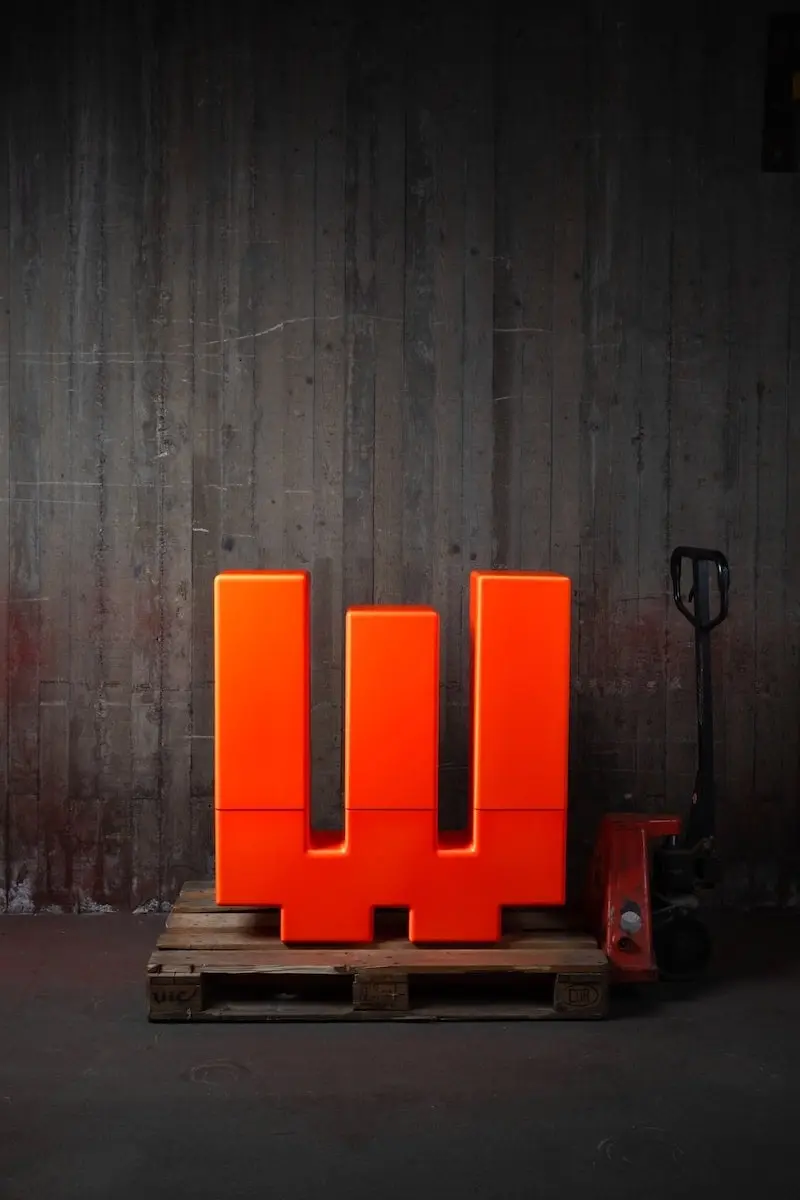 Fluorescent orange Inferno on a pallet with a pallet jack