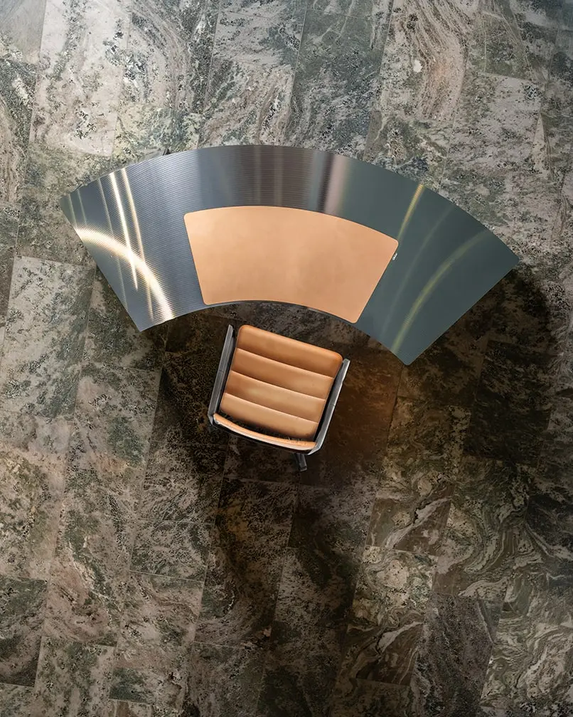 The CD desk and a leather chair seen from above on a marble floor