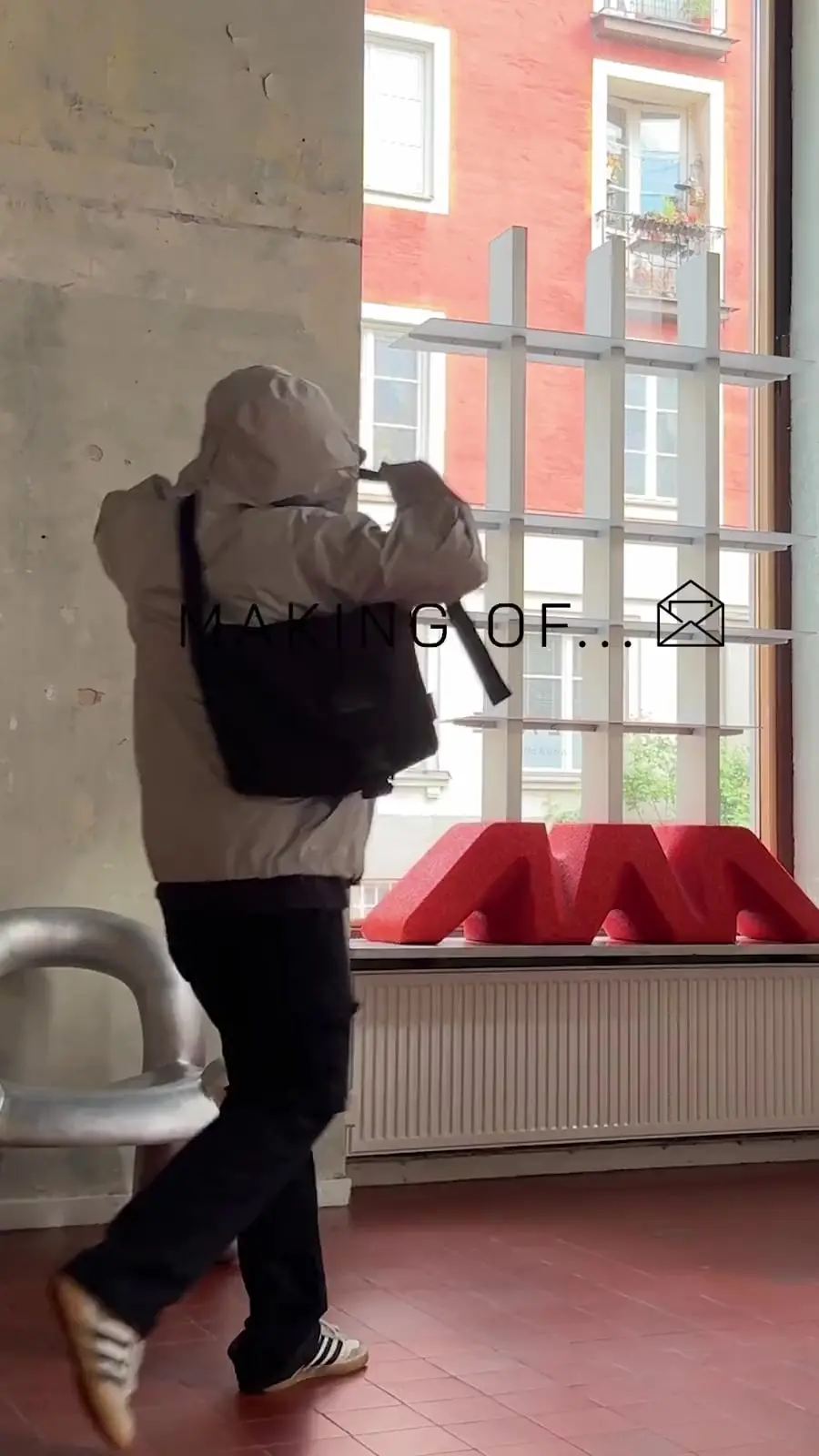 Video: a person carrying a vase past a shop window