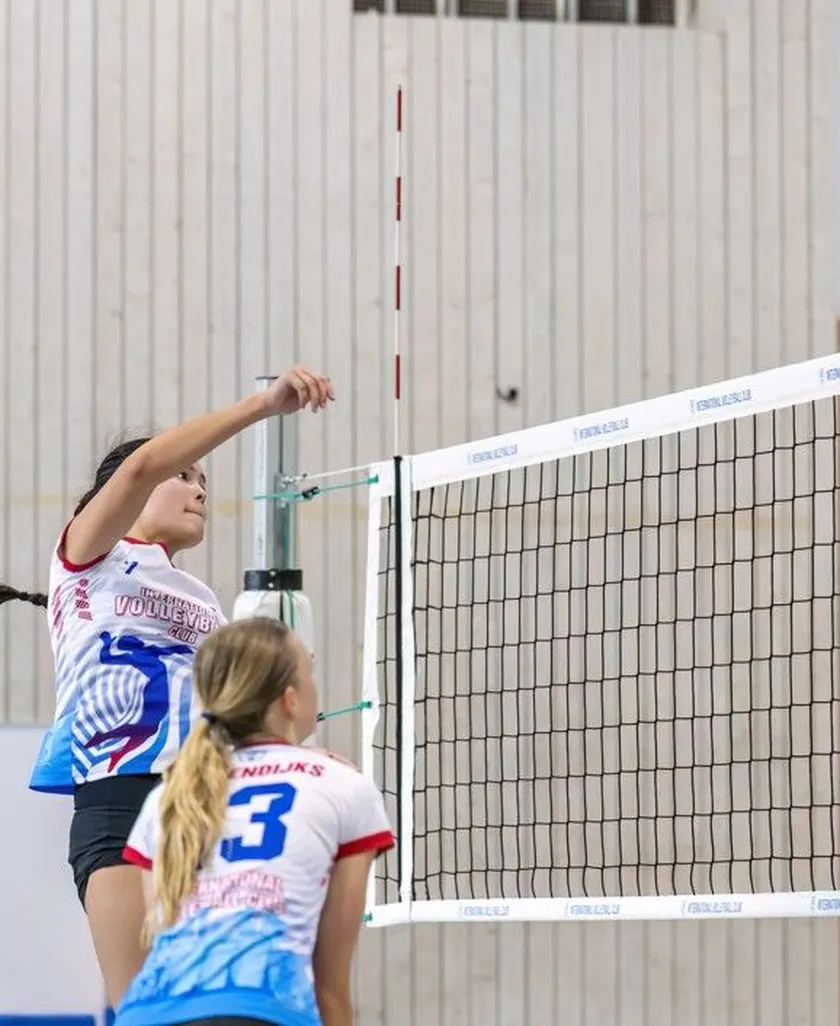 Youth volleyball match at the net