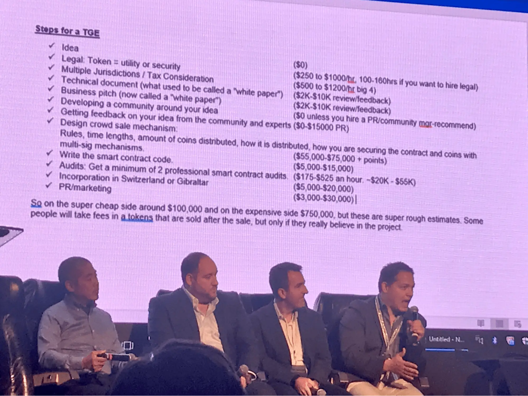 A photo from BlockCon 2017 featuring speakers discussing blockchain app development costs, with a slide displaying total prices from $100,000 to $750,000.
