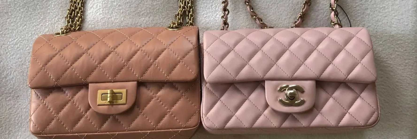 Two quilted handbags side by side, one in light brown with a gold clasp, the other in light pink with a branded emblem.