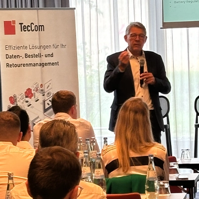 Speaker presenting at TecCom sustainability event with audience