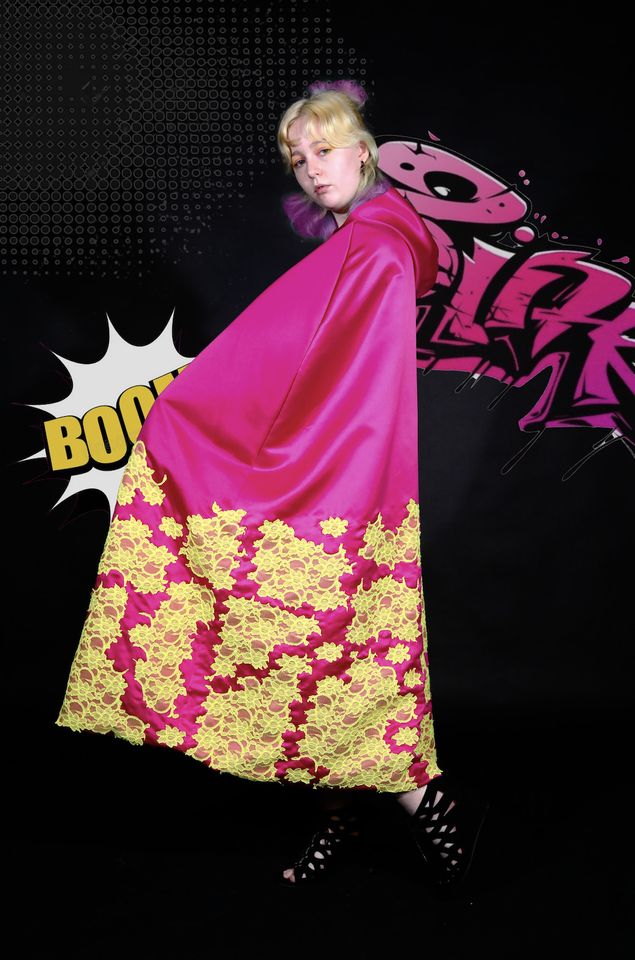Photo of female model wearing pink gown with yellow pattern on lower half