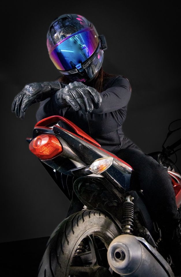 Photo of helmeted motorbike rider sitting wrong way round on bike