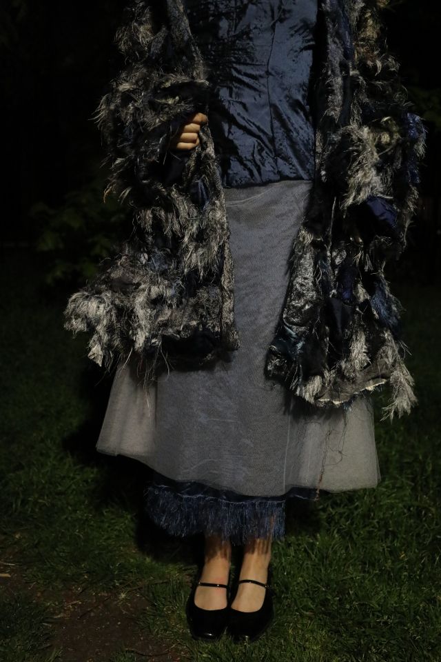 Photo of grey skirt and silver/blue coat being worn by model