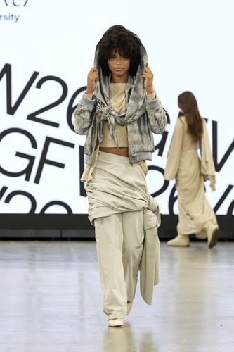 Female model wearing beige trousers and top with knitted grey hooded jacket GFW2026 catwalk