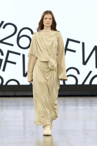 Female model wearing long beige gown on GFW2026 catwalk