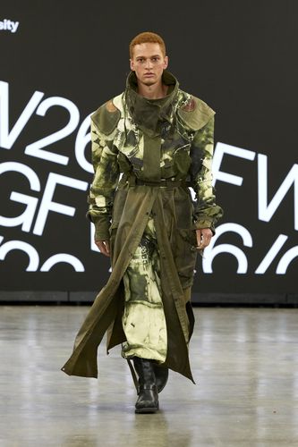 Male model wearing camo-style coat and trousers on GFW2026 catwalk