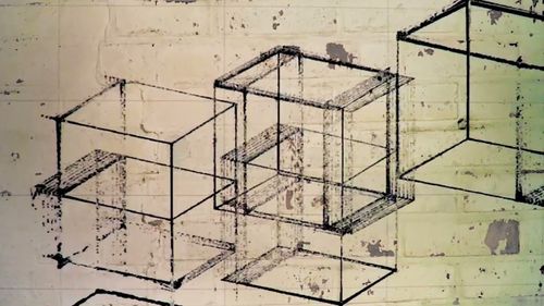 Video still showing wireframe cubes