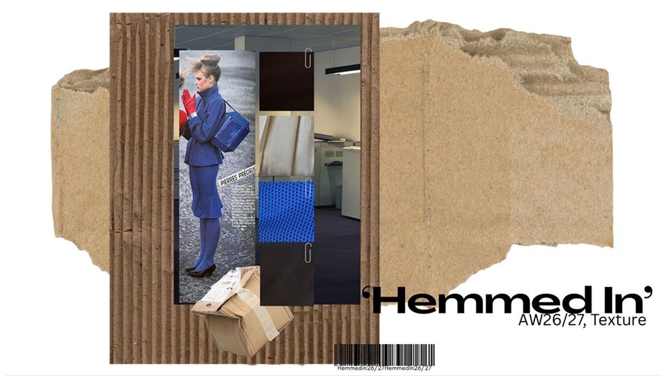 Photo of female model wearing all blue outfit and handbag with red gloves among cardboard