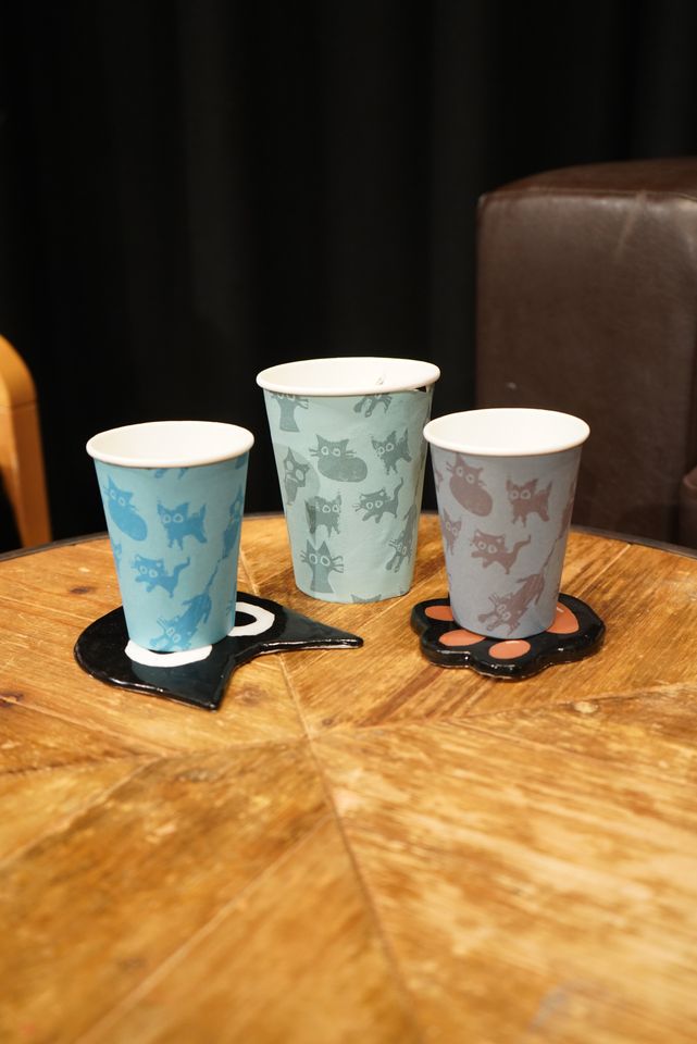 Three coffee cups with cats design on them in different colours