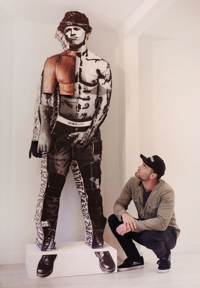 Photo of Endless crouching and looking up at cardboard cut-out of human male grabbing crotch