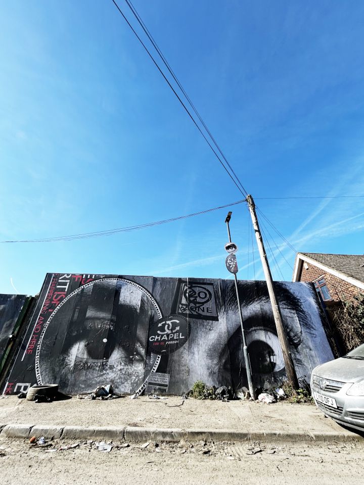 Endless poster on wall, featuring two black and white eyes, one in a large circle, the other wide open