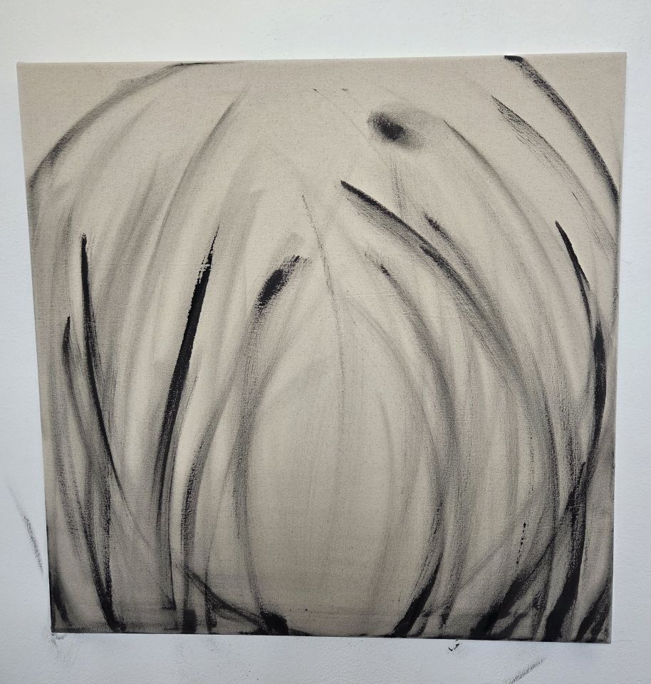 Black charcoal strokes designed to look like plants