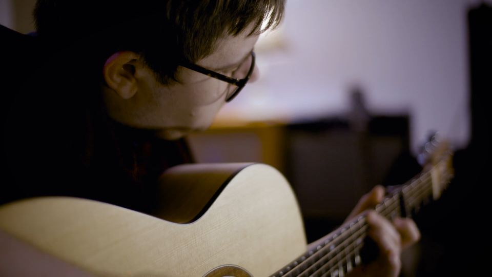 Dan Parry playing an acoustic guitar