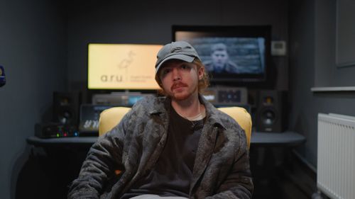 James Hartley sitting in an ARU film editing suite