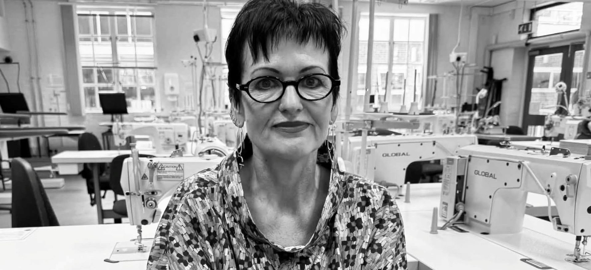 Black and white photo of Gunta Andrews in ARU's fashion workshop