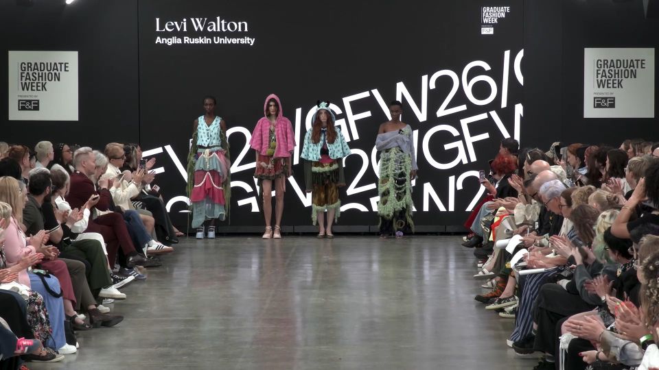 Four female models lined up in front of screen on GFW2026 catwalk wearing various colourful outfits