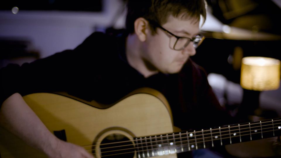 Dan Parry playing an acoustic guitar